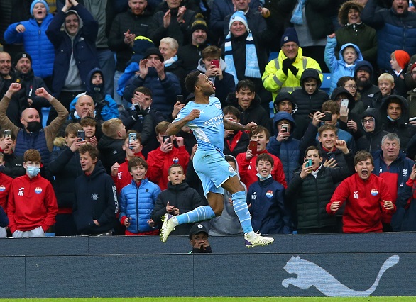 Raheem Sterling of Manchester City celebrates after scoring the opening goal from the penalty spot in the Premier League against Wolverhampton Wanderers at Etihad Stadium in Manchester on December 11 2021.