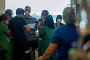 Medical professionals discuss care for coronavirus disease (Covid-19) patients at the Ochsner Medical Center in Jefferson Parish, Louisiana, US, August 10, 2021. 