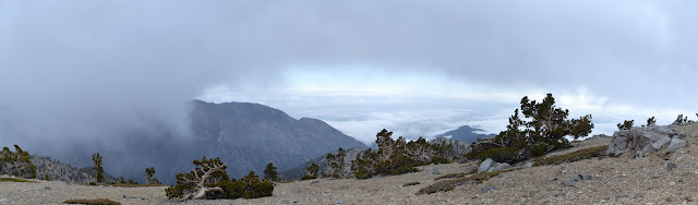 clouds surrounding an arrowhead of land