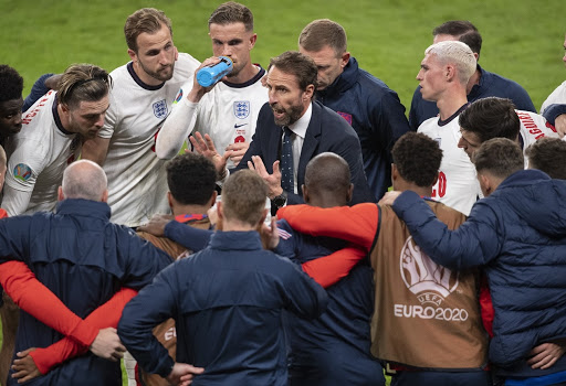 England manager Gareth Southgate talks to his players during the half-time break of extra time in the Uefa Euro 2020 Championship semi-final against Denmark at Wembley Stadium on July 07, 2021.