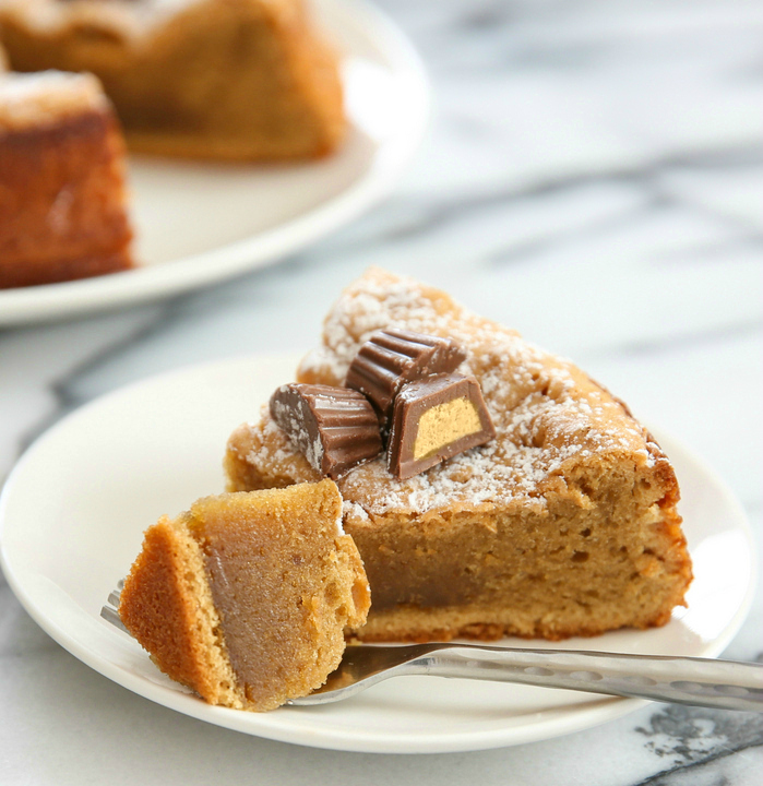 close-up photo of a fork slicing off a bite of cake