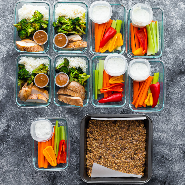 variety of foods in glass containers and baking tins on gray counter