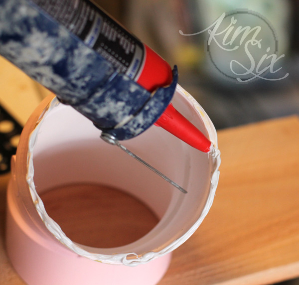 Using liquid nails to secure PVC planter to board