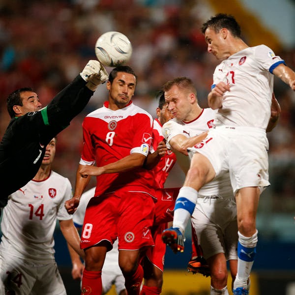 Malta's goalkeeper Justin Haber (L) clears a Czech Republic's attack during their 2014 World Cup qualifying soccer match at the National Stadium in Ta' Qali, outside Valletta.