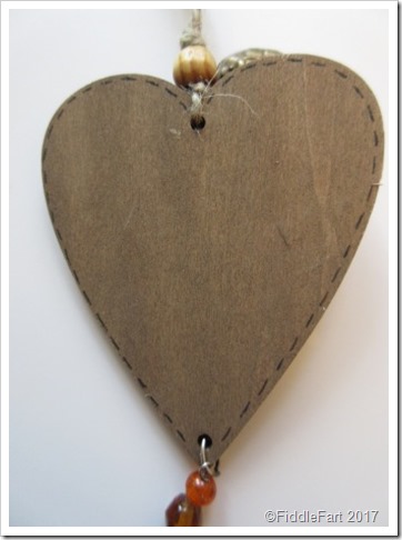 Faux stitching on back of wooden gift tag Faux stitching on back of wooden gift tag