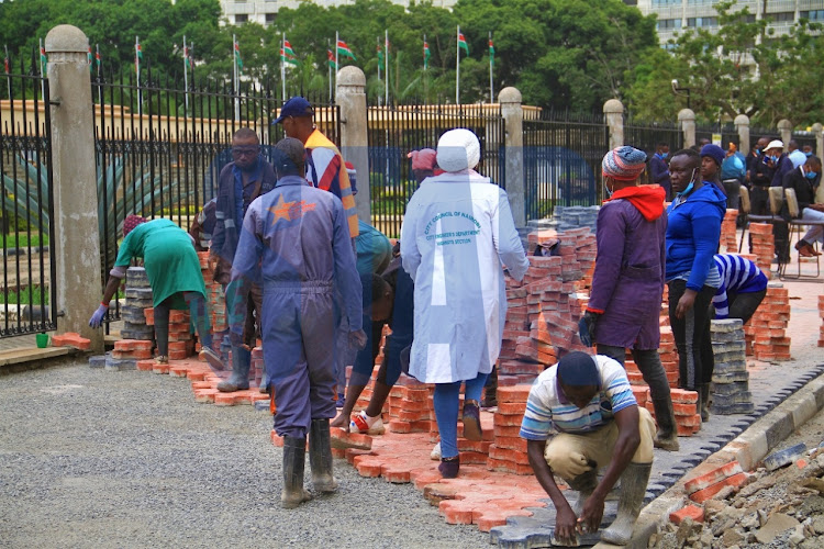 NMS workers arrange the cabros on the pavement along the Parliament Road in preparation for the budget reading on June.10th.2021.