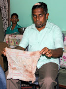 Local politician Abdul Saleel Mohamed Fazil, who alleges he was beaten by Sri Lankan police during anti-Muslim riots shows his bloody shirt in Kandy, Sri Lanka March 16, 2018. 