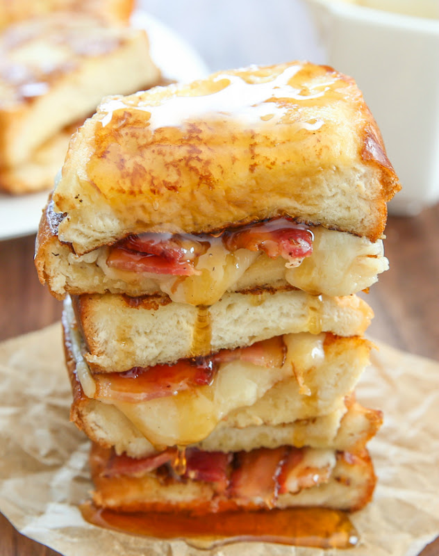 photo of a stack of french toast grilled cheese sandwiches topped with syrup