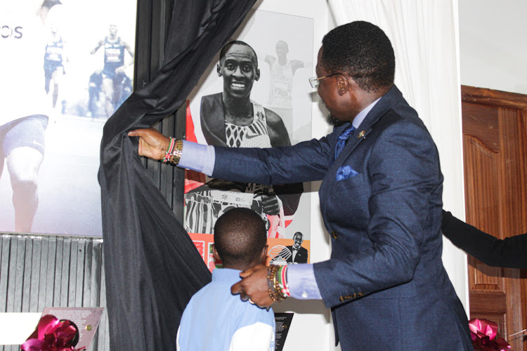 Sports CS Ababu Namwamba with the late Kelvin Kiptums son during the official induction of Kiptum to the Talanta hall of fame at the Talanta Plaza in Upperhill, Nairobi.