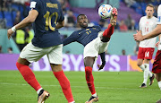 Ousmane Dembele of France in action during the World Cup Group D match against Denmark at Stadium 974 in Doha, Qatar on November 26 2022. Kylian Mbappe (obscured) has his back to the camera.