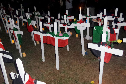 loss: A view of crosses dressed with Kenyan flags and flowers to honour the victims of Garissa attack during a Vigil at Uhuru Park