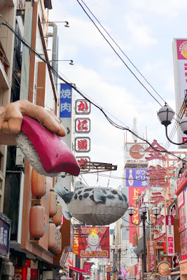 Sights of Osaka - the giant food signs of Dotonbori, including a giant sushi in a Big Hand that symbolizes Genroku Zushi and Zuboraya's fugu blowfish