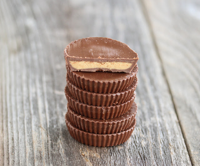 photo of a stack of peanut butter cups with the top one sliced in half