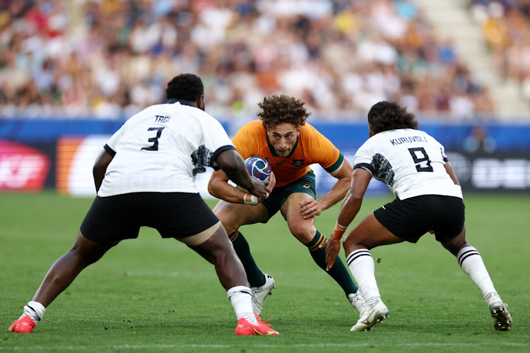 Mark Nawaqanitawase of Australia charges Luke Tagi and Simione Kuruvoli of Fiji during the Rugby World Cup France 2023 match between Australia and Fiji at Stade Geoffroy-Guichard in Saint-Etienne, France, September 17 2023. Picture: CHRIS HYDE/GETTY IMAGES