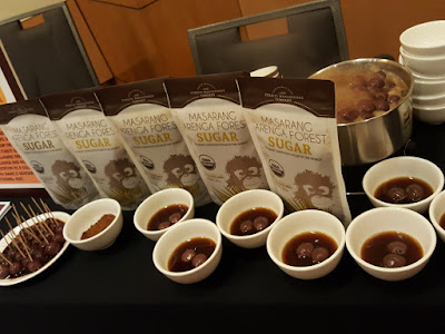 Masarang sugar is used in the preparation of these ginger syrup tangyuan. The sugar is a deep brown and can be seen in the bowl to the left.