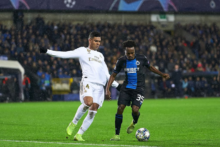 Percy Tau of Club Brugge KV competes for the ball with Casemiro of Real Madrid during a UEFA Champions League group A match at Jan Breydel Stadium