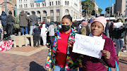 Taxi associations, business owners and members of the public gather at the city hall in Gqeberha to demonstrate their opposition to looting in the city.