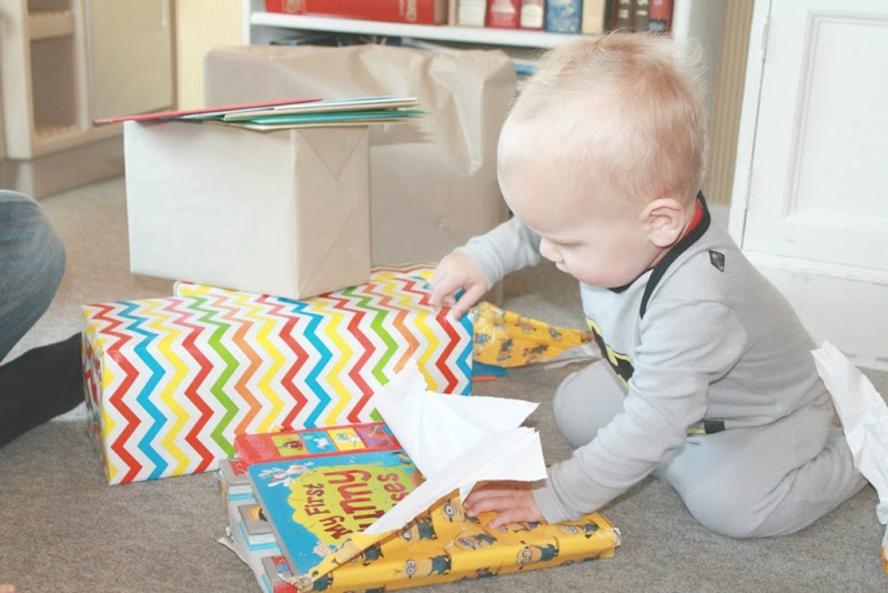 baby-tearing-wrapping-paper-off-gift