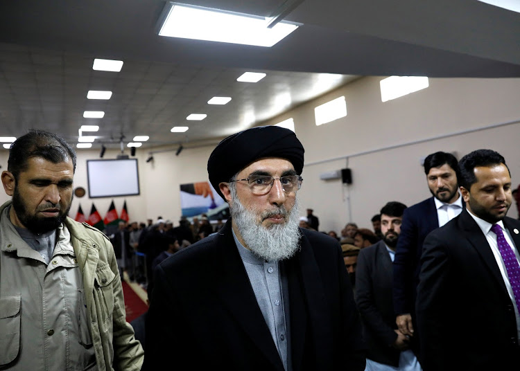 Former Afghan warlord Gulbuddin Hekmatyar (C) leaves after registering as a candidate for the presidential election at Afghanistan's Independent Election Commission (IEC) in Kabul, Afghanistan January 19, 2019.