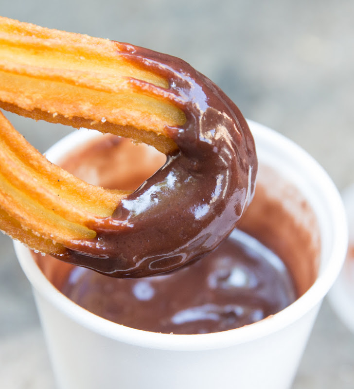 close-up photo of a chocolate dipped churro