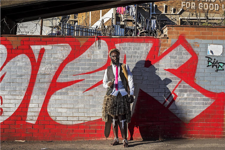 Security guard Menzi Mhlongo passes street art by Siek MHC on his way to a Shembe church gathering City and Suburban 2018.