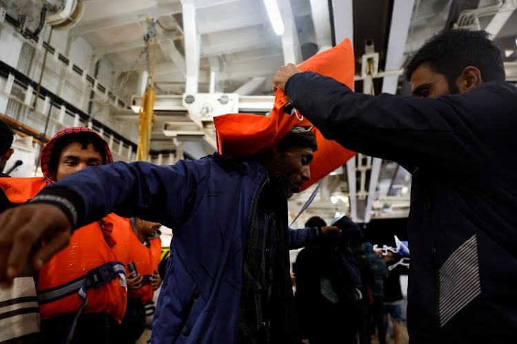 Migrants remove their life jackets on the Geo Barents rescue ship, operated by Medecins Sans Frontieres, after being rescued from a wooden boat off the coast of Libya in the central Mediterranean Sea March 24 2023. Picture: DARRIN ZAMMIT LUPI/REUTERS