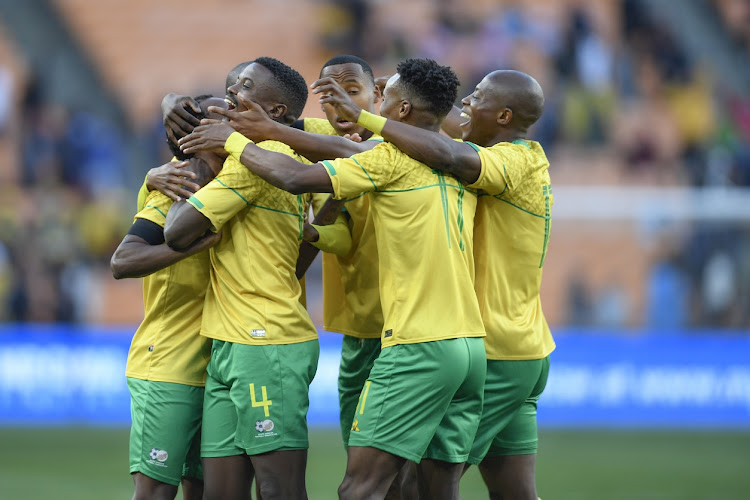 Bafana Bafana players celebrate a goal by Percy Tau (obsured) in their 2-1 Africa Cup of Nations qualifying win against Morocco at FNB Stadium on June 17 2023.