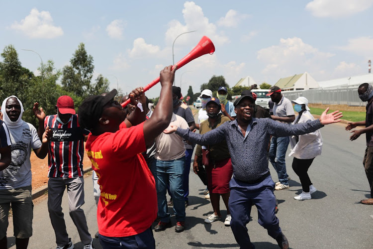 Striking Clover workers sing struggle songs. File photo.