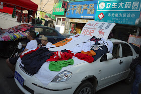 Abercrombie & Fitch clothes for sale on top of a car