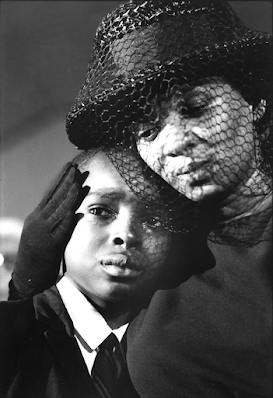 black nd withe photo of Mrs. Cheney hugging young Ben Chaney at James Chaney;'s funeral, 1964