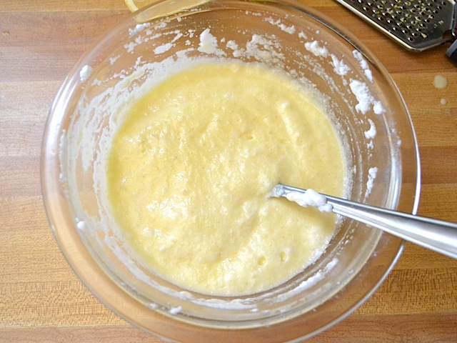 lemon mixture folded into egg whites in bowl 