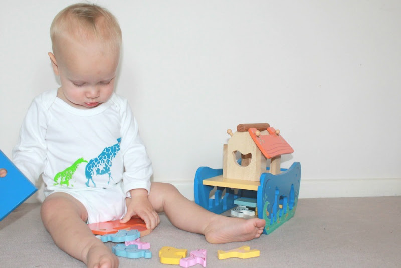 baby-playing-with-wooden-toy-boat