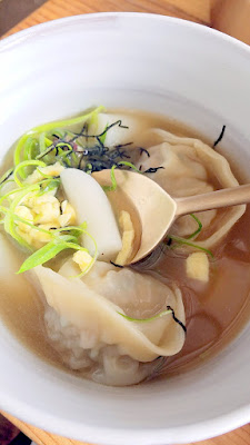 Han Oak, A bowl of pork and chive dumpling soup with beef broth, rice cake, egg and nori