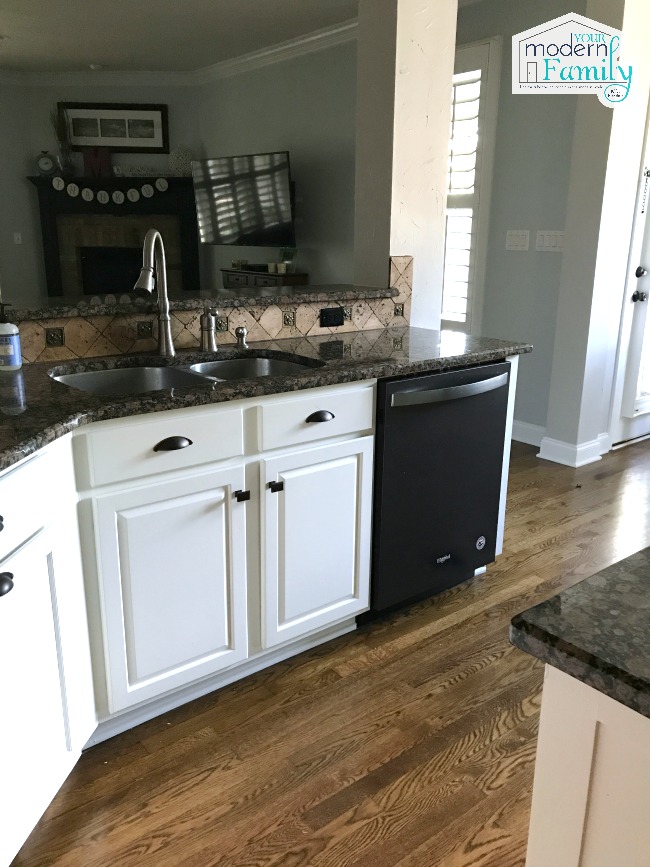 A kitchen with a stove and a sink.