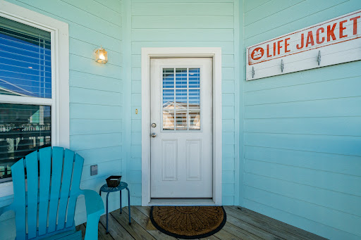 White door on light blue wall, chair - Buy this luxury property in Rockport, 2 bedrooms