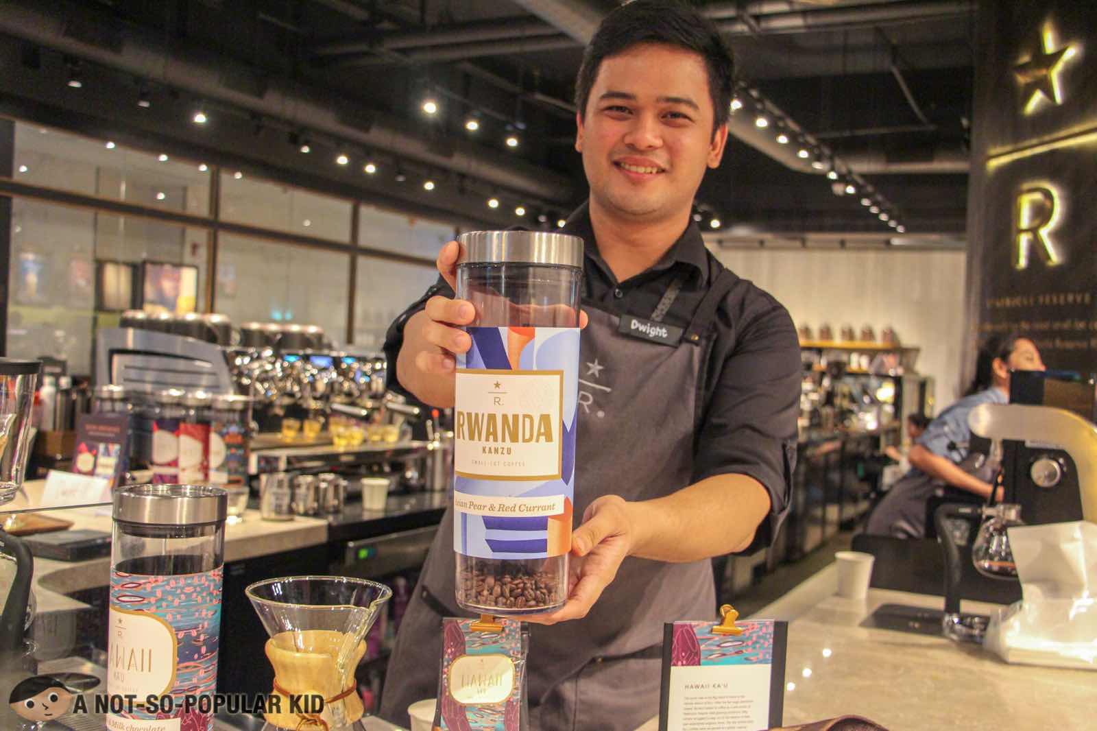 Dwight holding Rwanda Kanzu Coffee in Starbucks Reserve