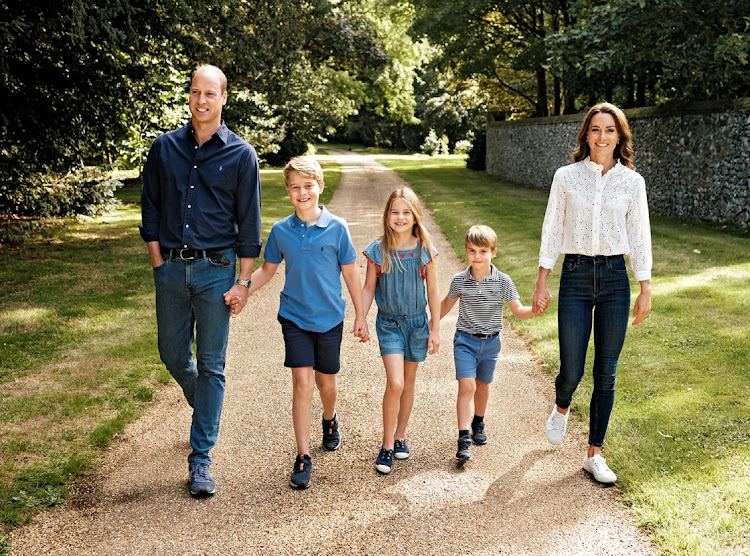 The Prince and Princess of Wales, Prince George, Princess Charlotte and Prince Louis walk in Norfolk in this undated photo released as a Christmas card on December 13 2022.