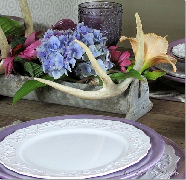 Antlers and a salvaged chicken feeder with fresh flowers for a pretty and unusual centerpiece