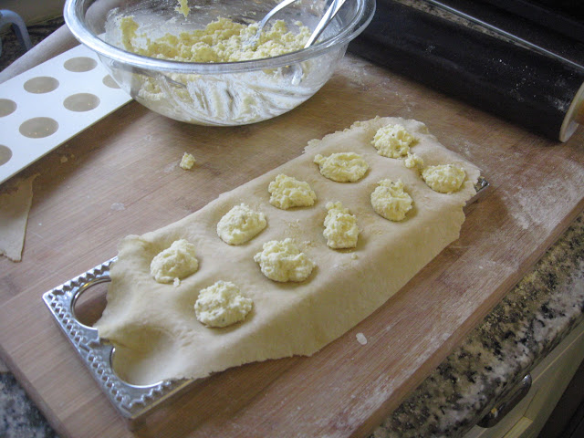 Stuffing the ravioli with ricotta filling.