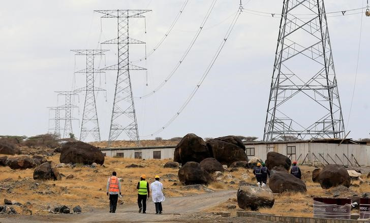 Workers walk near power lines in Loiyangalani district, Kenya, September 4 2018. Picture: REUTERS/THOMAS MUKOYA