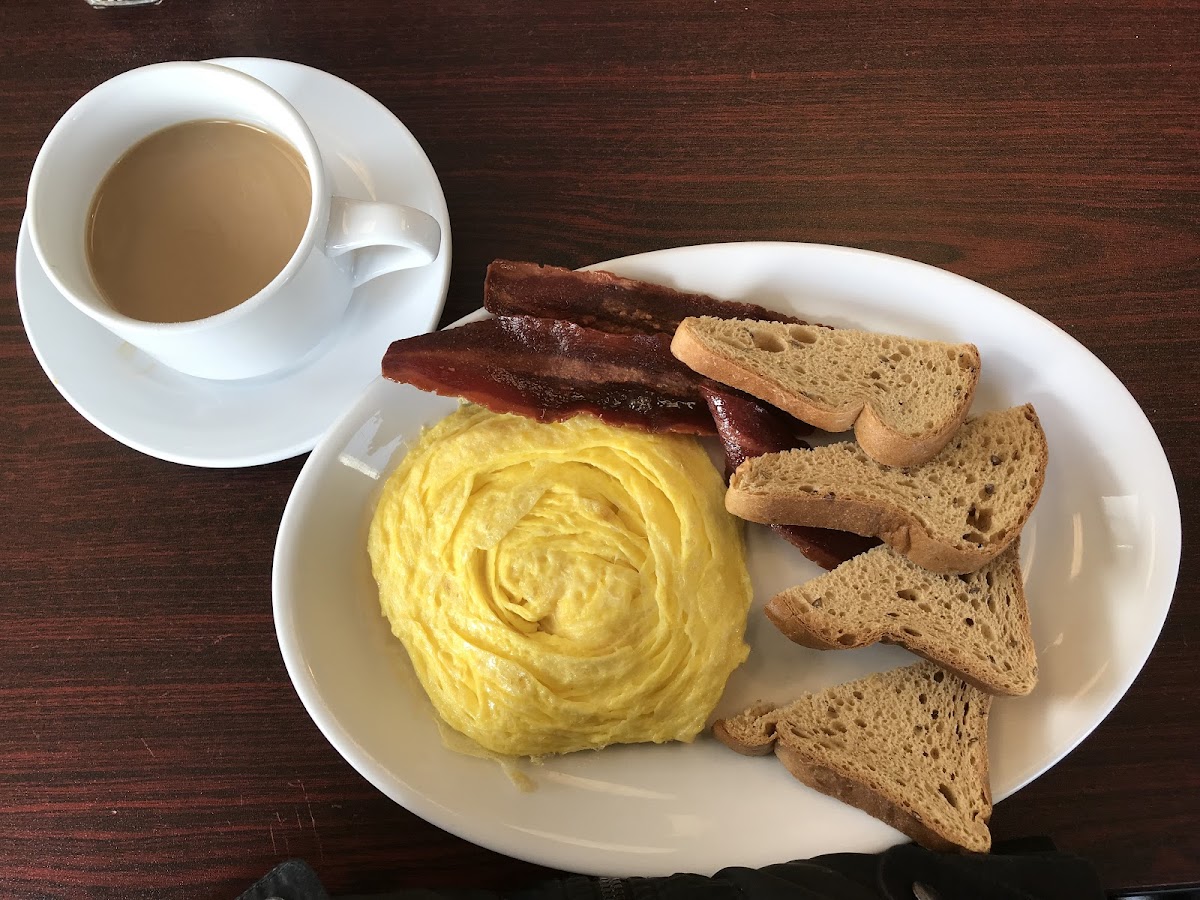 Organic coffee with cream, scrambled egg, turkey bacon and multigrain GF toast.