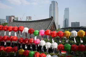 lanterns at Bongeunsa Temple with city skyline in the background