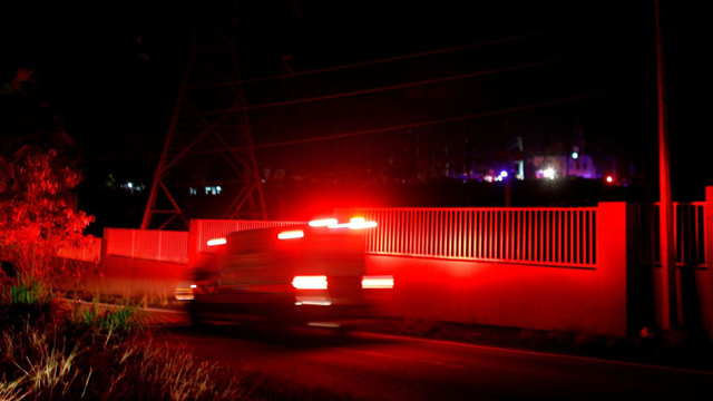 An ambulance rushes toward an electric substation in San Juan, Puerto Rico, after an explosion and fire caused a blackout across part of the island on 11 February 2018. Photo: Ricardo Arduengo / AFP / Getty Images