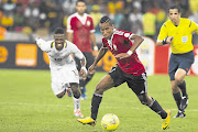 BITTER VICTORY: Elmehdi Mohamed Elhouni, right, and Abraham Asiedu Attobrah during the 2014 African Nations Championship final match between Libya and Ghana, who lost the game, at Cape Town Stadium yesterday. Picture: Gallo Images