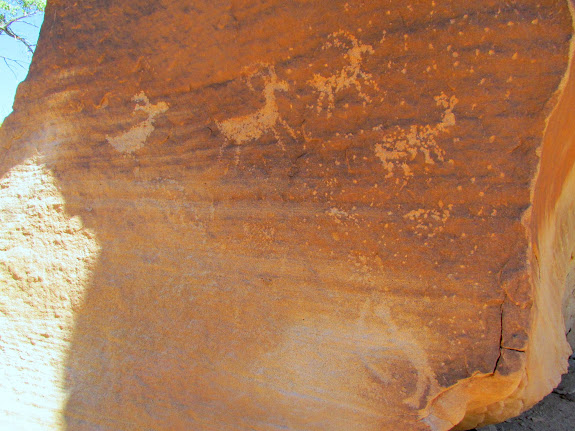 Bighorn sheep petroglyphs and an archer at the lower-right