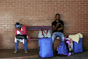 FULL STOP: Stranded commuters wait at Durban's main terminal in the hope of getting on a bus before tomorrow.