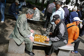 two men playing janggi (Korean Chess) at a park in Seoul