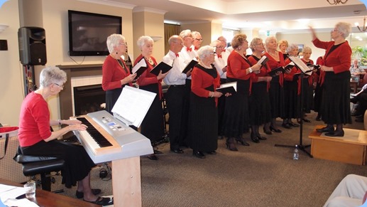 the Evelyn Page Village Choir with choir master, Julia Bissett and pianist Patricia. Photo courtesy of Dennis Lyons.