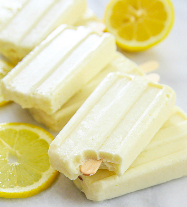 close-up photo of a lemon ice pop with a bite taken out of it