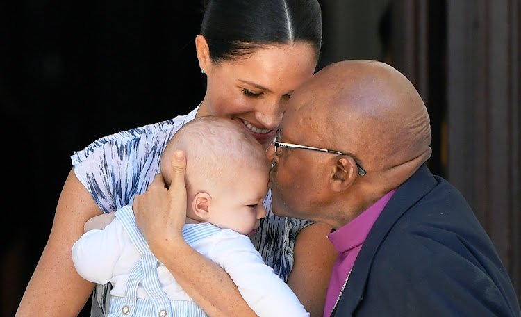 Archbishop Emeritus Desmond Tutu plants a kiss on the forehead of five-month-old Archie, who was introduced to him by his parents the Duke and Duchess of Sussex in Cape Town on September 25 2019.